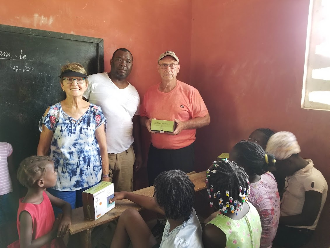 Dave Jerilyn Distributing Solar Lamps In Haiti